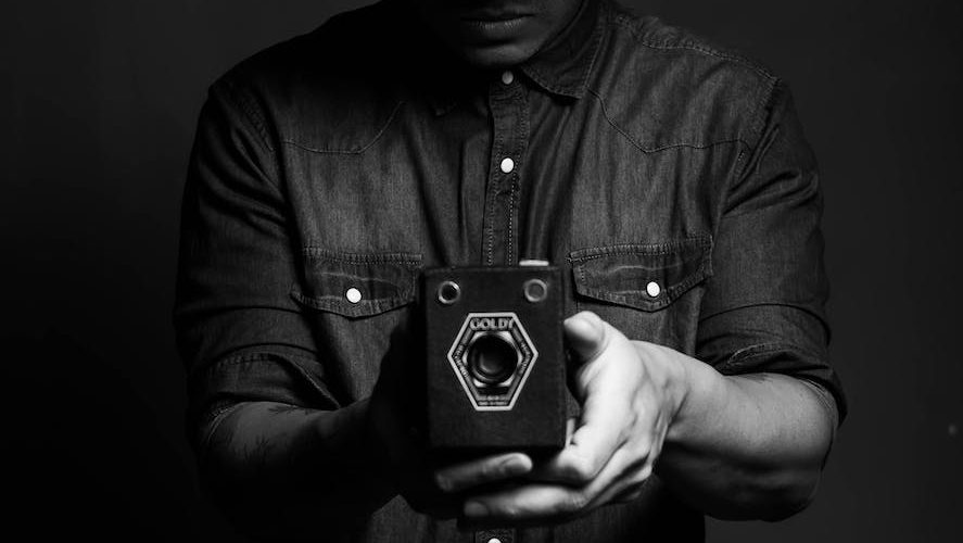 male photographer using vintage camera